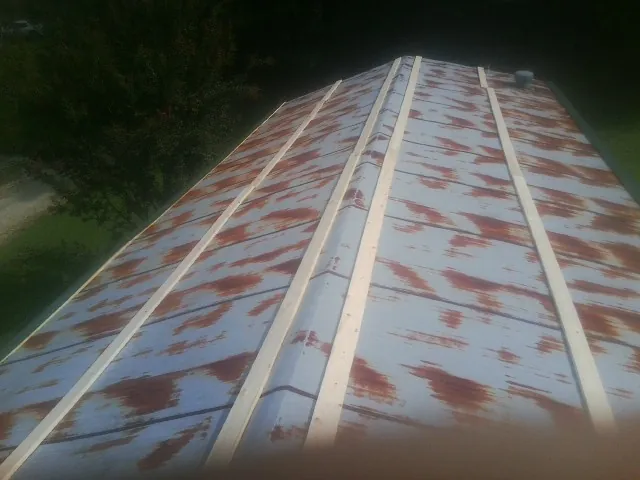 Rusted metal roof panels with new wood purlins before replacement — Storm Damage Roof Repair in Mars by Roofing Brothers