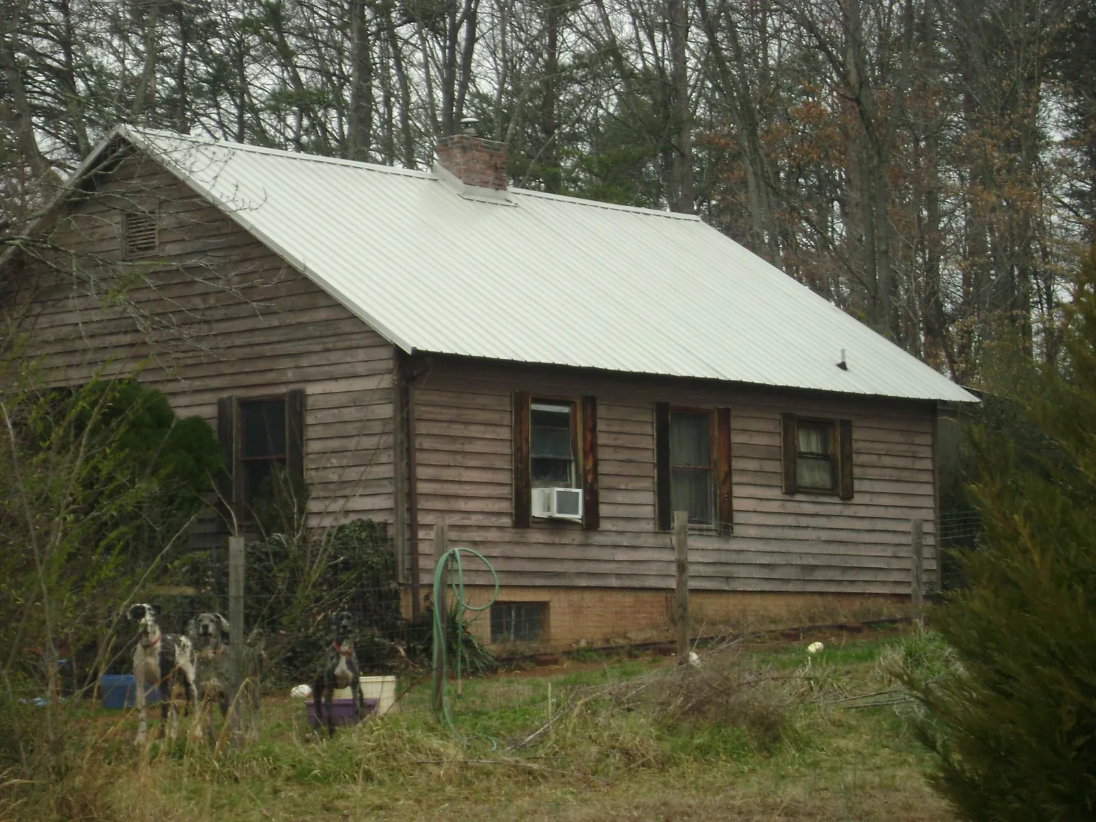 White metal roof on an old wood sided farmhouse, from a Metal Roof Installation job in Mars